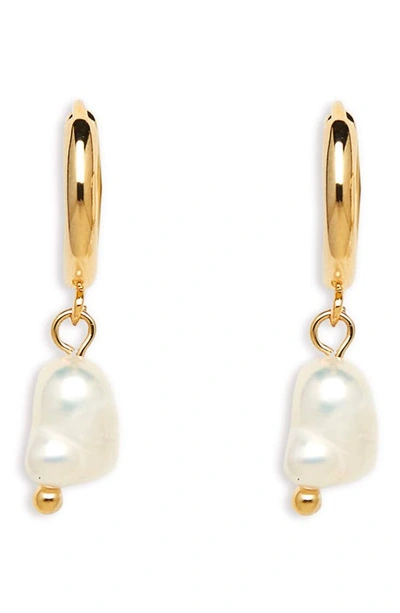 Shop Petit Moments Alexandria Pearl Drop Huggie Hoop Earrings In Gold
