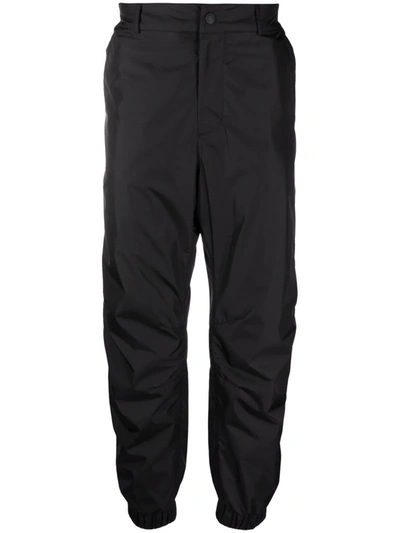 Shop Moncler Cuffed Straight-leg Trousers In Black