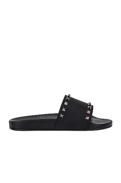 Shop Valentino Rockstud Slide Sandals In Black