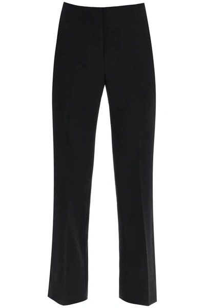 Shop Versace Wool Natté Trousers In Black