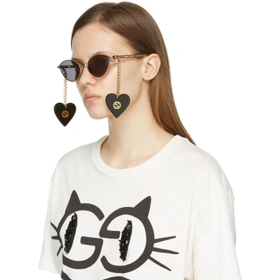 Shop Gucci Gold Chain Cat-eye Sunglasses In 001 Gold