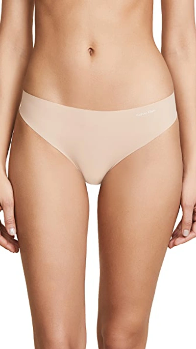 Shop Calvin Klein Underwear Invisibles Thong Light Caramel