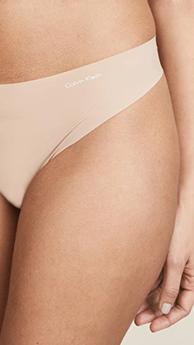 Shop Calvin Klein Underwear Invisibles Thong Light Caramel