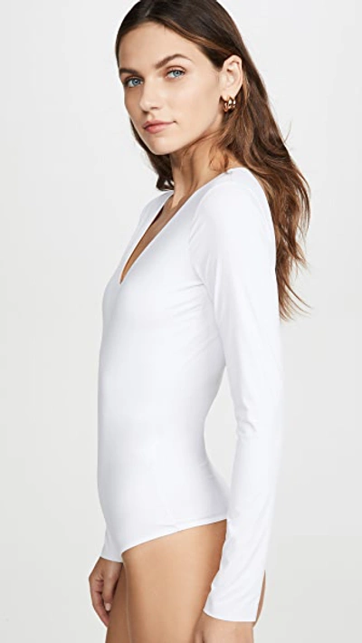 Shop Wolford Long Sleeve V Neck Thong Bodysuit In White