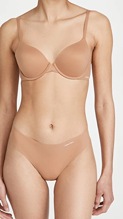 Shop Calvin Klein Underwear Invisibles Thong In Sandalwood