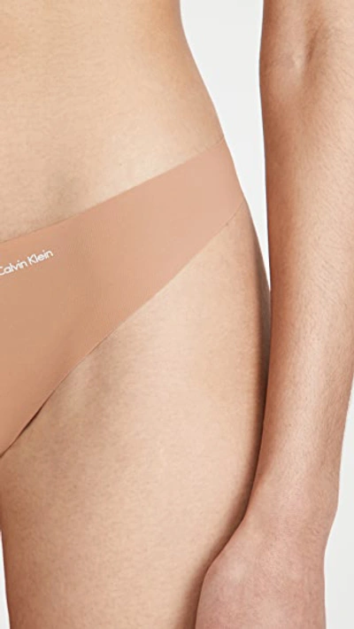 Shop Calvin Klein Underwear Invisibles Thong In Sandalwood