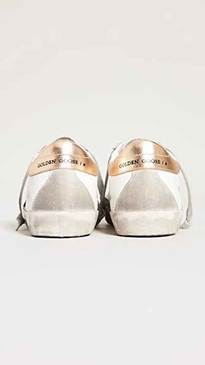 Shop Golden Goose Superstar Sneakers White/silver/gold