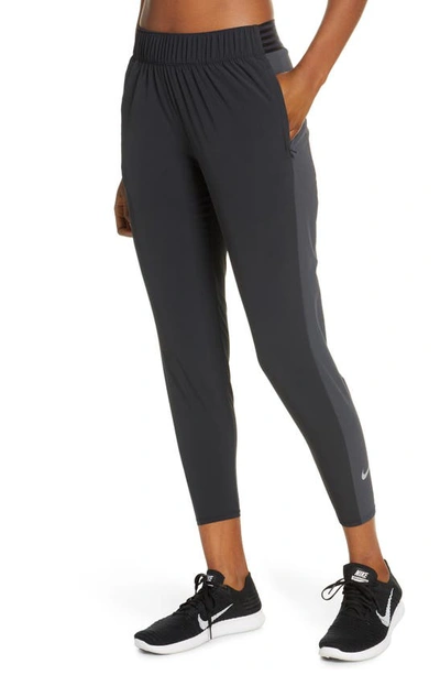 Shop Nike Essential 7/8 Running Pants In Black/ Dk Smoke Grey/