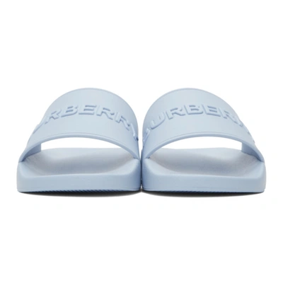 Shop Burberry Embossed Logo Slides In Pale Blue