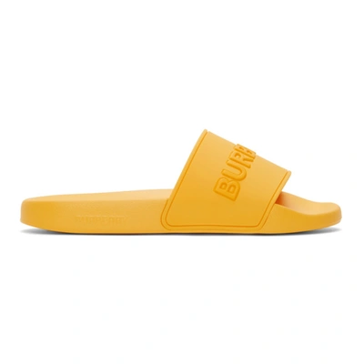 Shop Burberry Embossed Logo Slides In Yellow