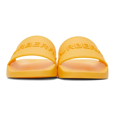 Shop Burberry Embossed Logo Slides In Yellow