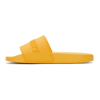 Shop Burberry Embossed Logo Slides In Yellow