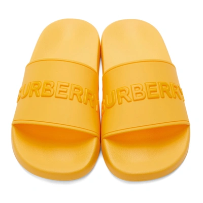 Shop Burberry Embossed Logo Slides In Yellow