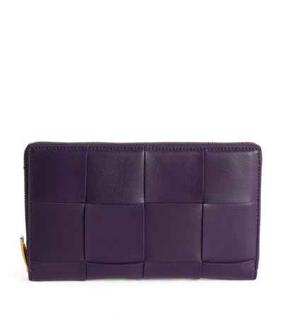 Shop Bottega Veneta Leather Intreccio Zip-around Wallet In Purple