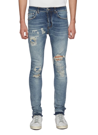 Shop Purple Ripped And Repaired Low Rise Light Washed Skinny Jeans In Blue