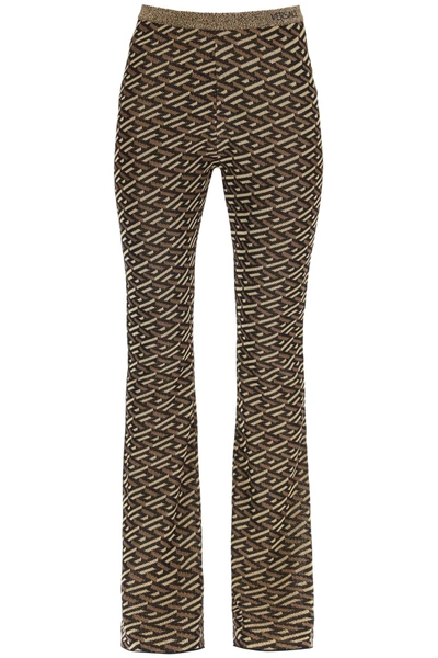 Shop Versace La Greca Jacquard Lurex Knit Trousers In Black,gold,brown