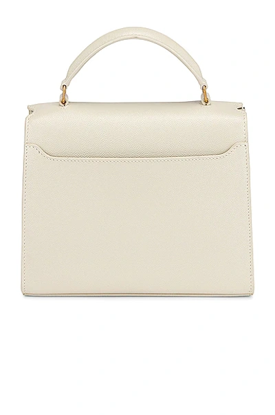 Shop Saint Laurent Mini Cassandra Top Handle Bag In Crema Soft