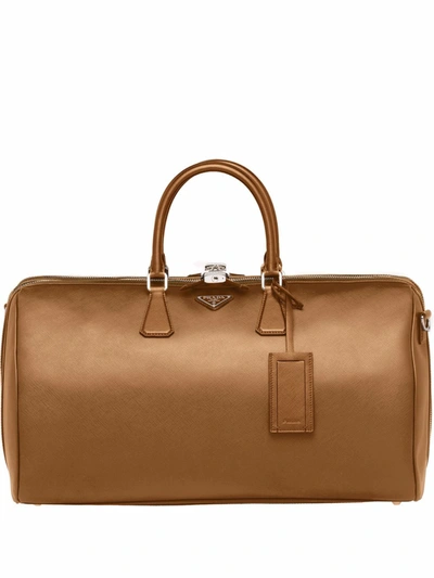 Shop Prada Logo Plaque Duffle Bag In Brown