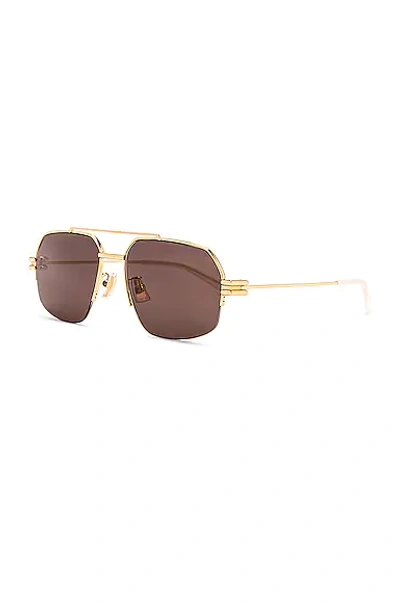 Shop Bottega Veneta Lock Pilot Sunglasses In Shiny Gold Lv