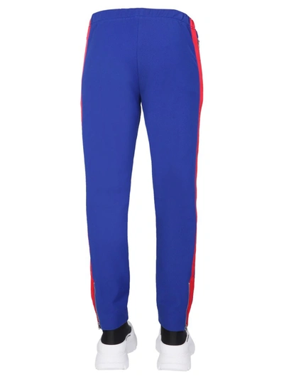 Shop Alexander Mcqueen Jogging Pants With Embroidered Skull In Blue
