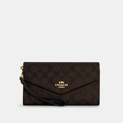 Shop Coach Travel Envelope Wallet In Signature Canvas In Brown