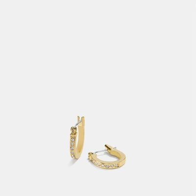 Shop Coach Pave Signature Huggie Earrings In Yellow
