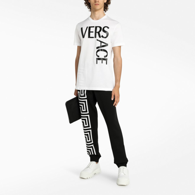 Shop Versace Black Jogging Trousers With Greca Motif