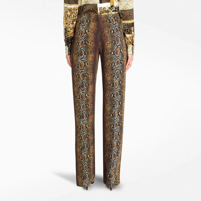 Shop Versace Phyton Print Trousers In Brown