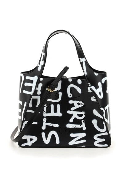 Shop Stella Mccartney Graffiti Logo Tote Bag In Black (black)