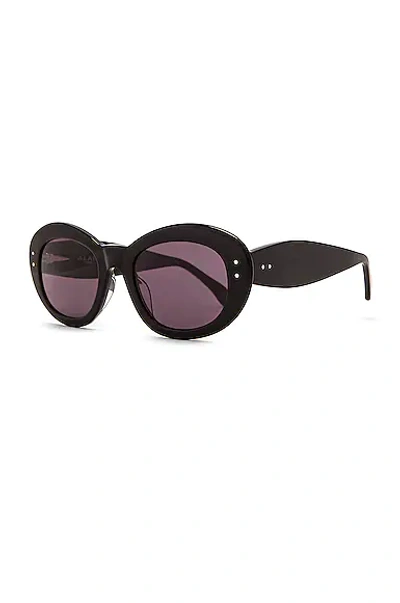 Shop Alaïa Oval Sunglasses In Shiny Black