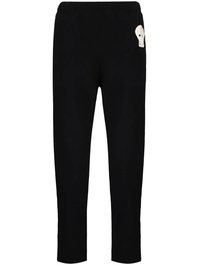 Shop Alexander Mcqueen Skull-embroidered Zip-ankle Tack Pants In Black