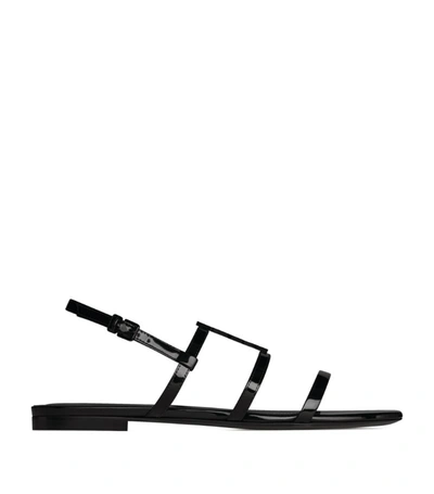 Shop Saint Laurent Leather Cassandra Flat Sandals In Black