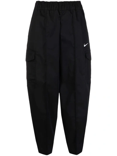 Shop Nike Curve Woven Tapered Trousers In Schwarz