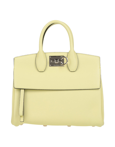 Shop Ferragamo Handbags In Yellow