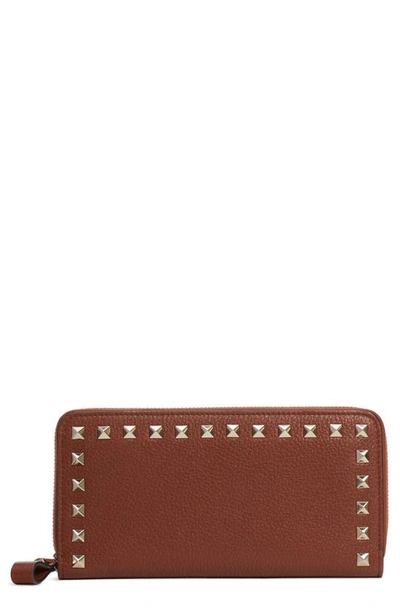 Shop Valentino Rockstud Zip Around Leather Continental Wallet In Bright Cognac