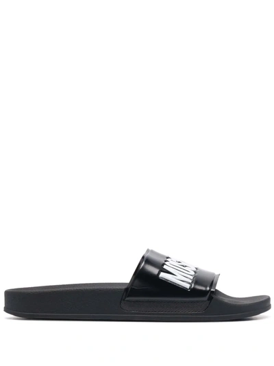 Shop Moschino Logo Embossed Slides In Black