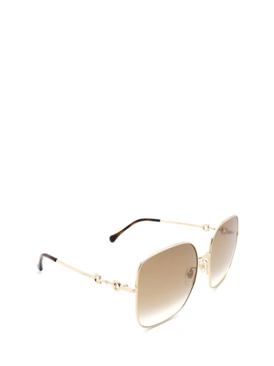 Shop Gucci Eyewear Sunglasses In Gold