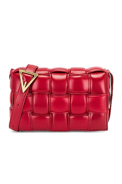 Shop Bottega Veneta Padded Cassette Bag In Dark Red & Gold