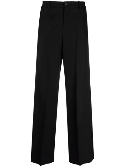 Shop Balenciaga Pressed-crease Four-pocket Flared Trousers In Schwarz