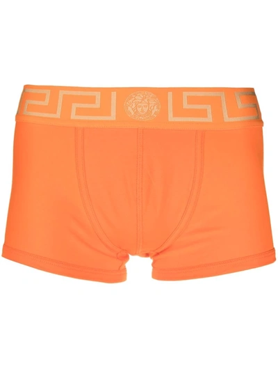 Shop Versace Greca Border Boxer Shorts In 橘色