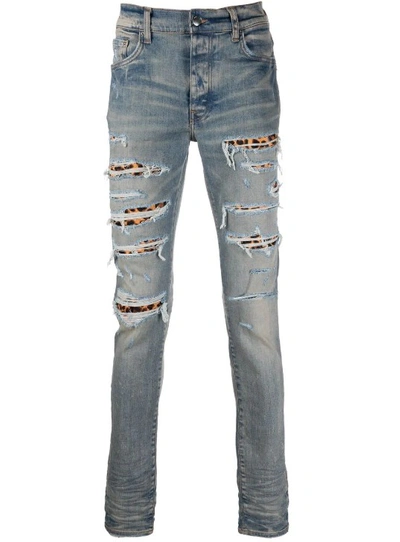 Shop Amiri Blue Ripped-detail Denim Jeans