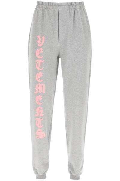 Shop Vetements Jogging Trousers With Anarchy Gothic Logo In Grey Melange Baby Pink (grey)