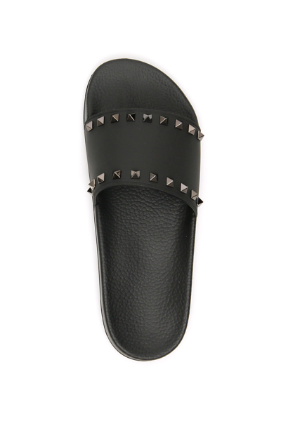 Shop Valentino Rockstud Rubber Slides In Black