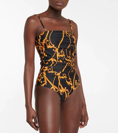 Shop Ganni Printed Ruched Swimsuit In Black