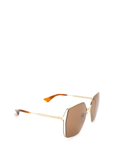 Shop Gucci Eyewear Sunglasses In Gold