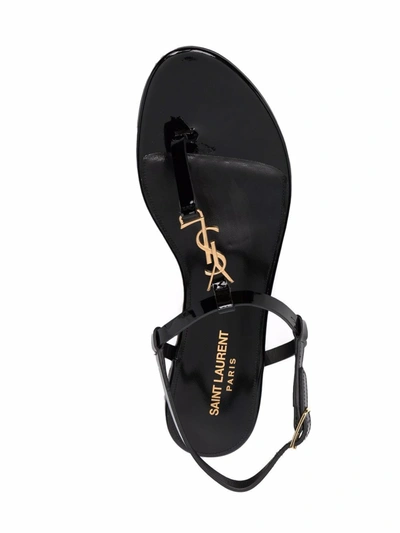 Shop Saint Laurent Cassandra Leather Flat Sandals In Black