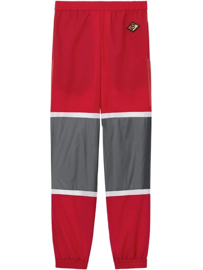 Shop Burberry Striped Nylon Logo Graphic Trackpants In Bright Red