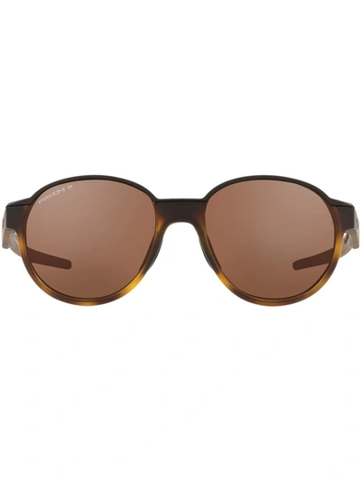 Shop Oakley Coinflip Round Frame Sunglasses In Brown
