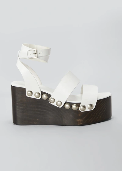 Shop Alaïa 85mm Wooden-heel Wedge Sandals With Shiny Leather Straps And Studs In 020 Blanc Casse