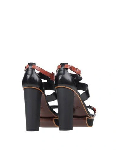 Shop Tod's Sandals In Black